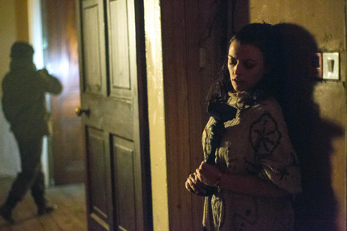 Nora-Jane holds a weapon